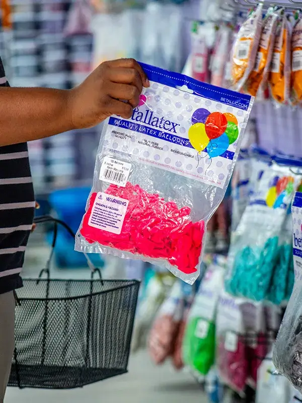 A customer holding a bag of balloons